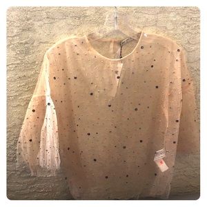 See through beaded shirt.